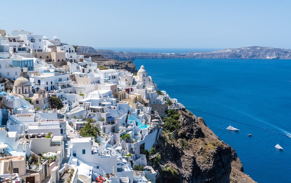 Beautiful Santorini houses overlooking the Aegean Sea on a sunny day.